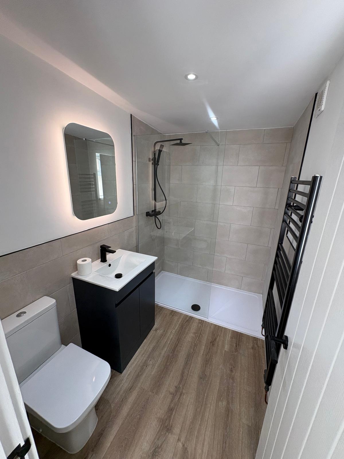 Finished bathroom with shower and black fixtures